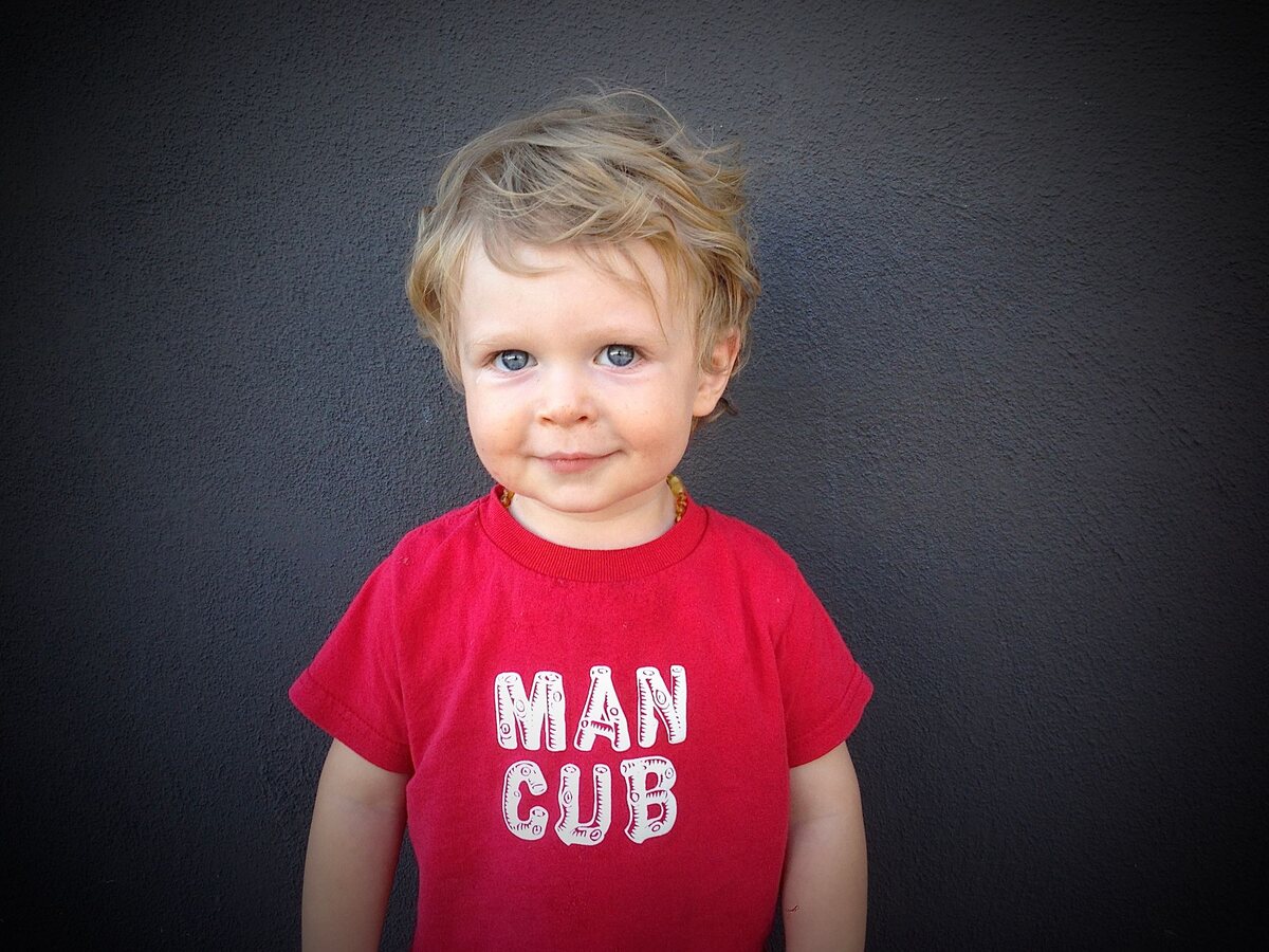 The original Echo Park Baby: a blond toddler in a red Man Cub T-shirt